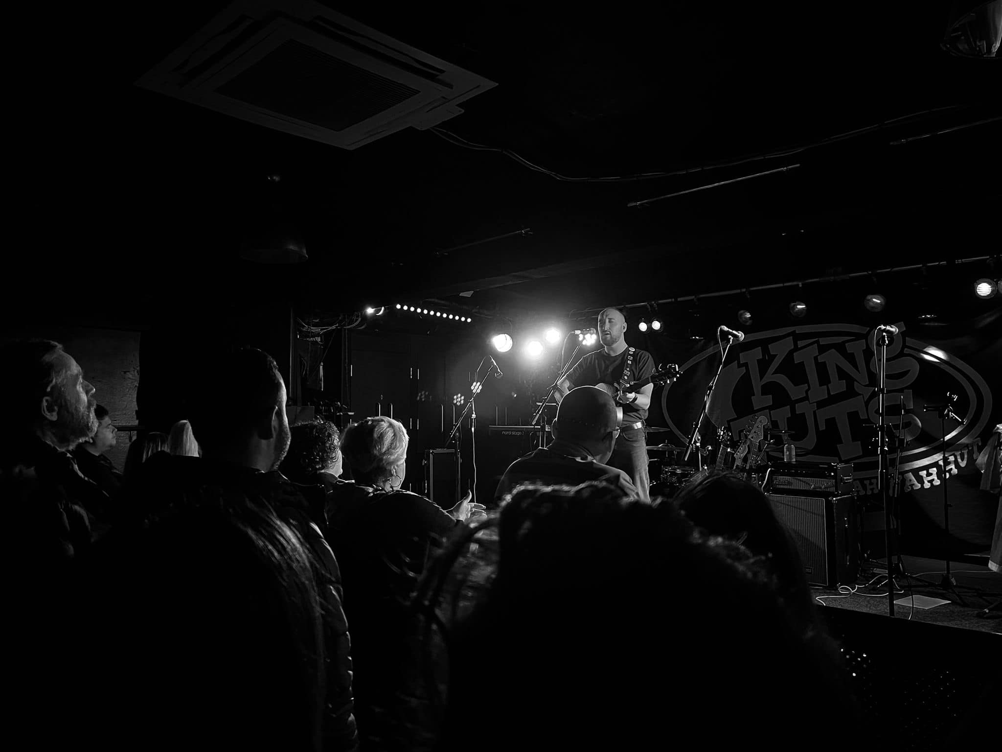Calum Baird on the stage - performing to a full back audience
