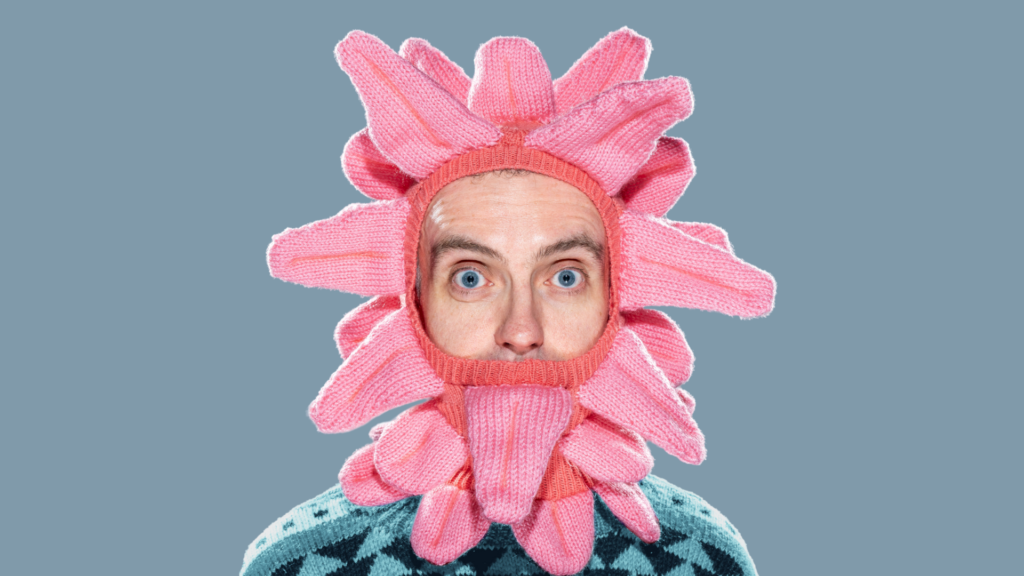 Images for Tongue Twister, a man is wearing a knitted full head baclava of tongues